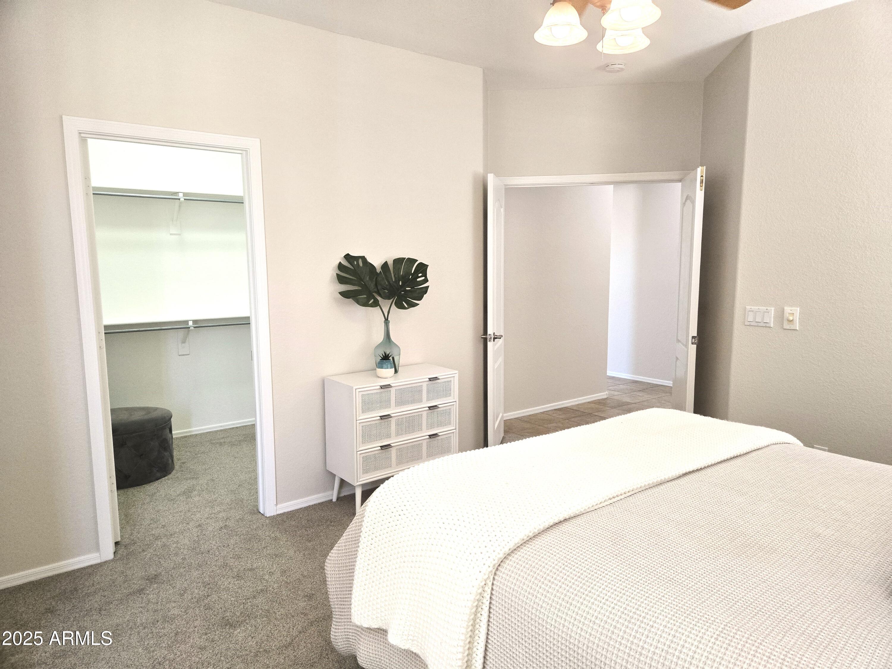 1187 South Hazel Street Gilbert, AZ 85296 - Photo 19 of 50 a bedroom with a bed and a painting on the wall