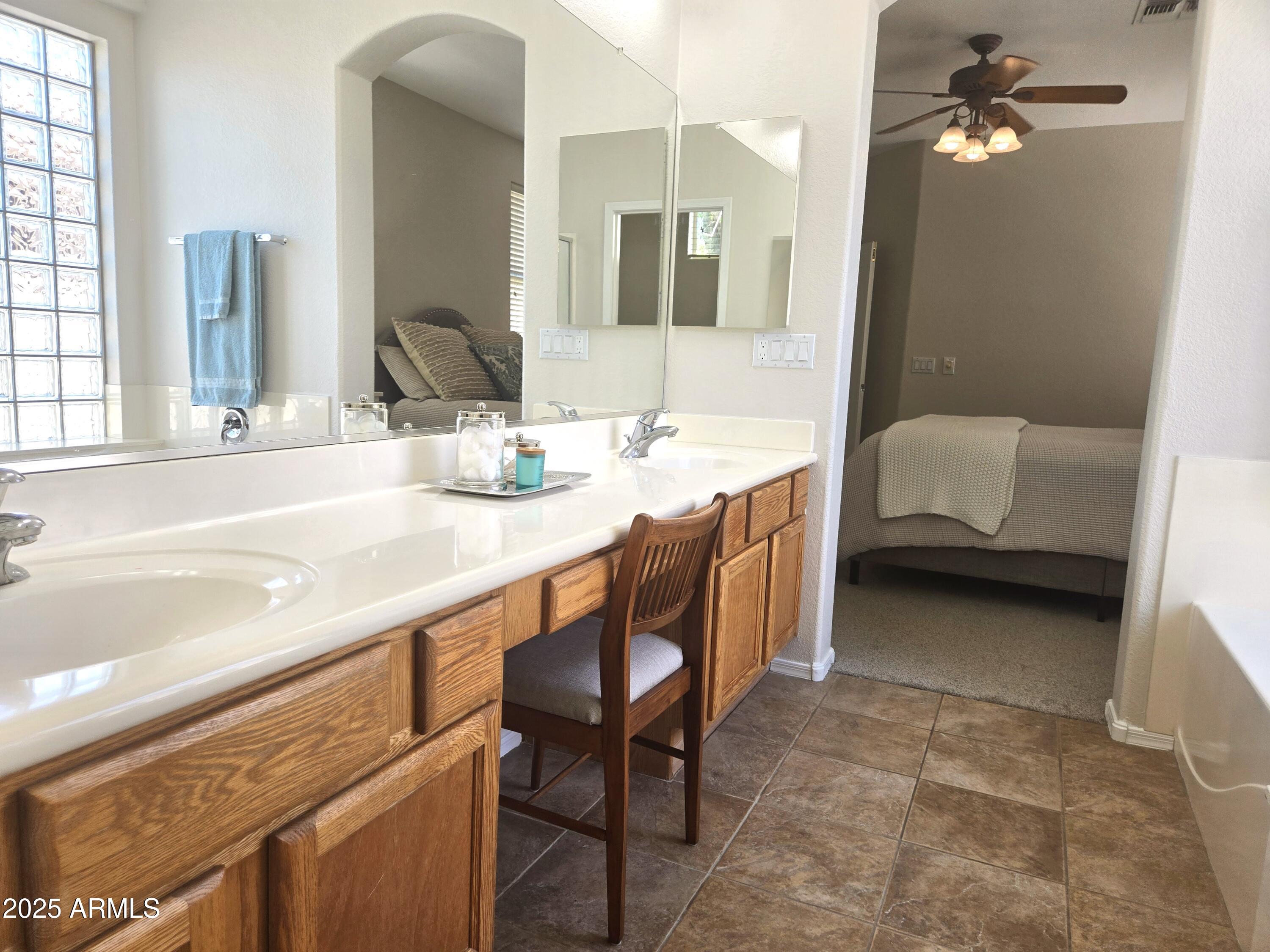 1187 South Hazel Street Gilbert, AZ 85296 - Photo 22 of 50 a en suite bathroom with a granite countertop sink a mirror and a bathtub