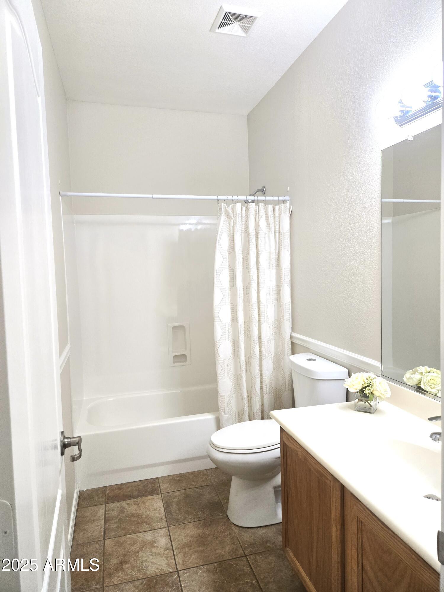 1187 South Hazel Street Gilbert, AZ 85296 - Photo 29 of 50 a bathroom with a sink a toilet a mirror and shower