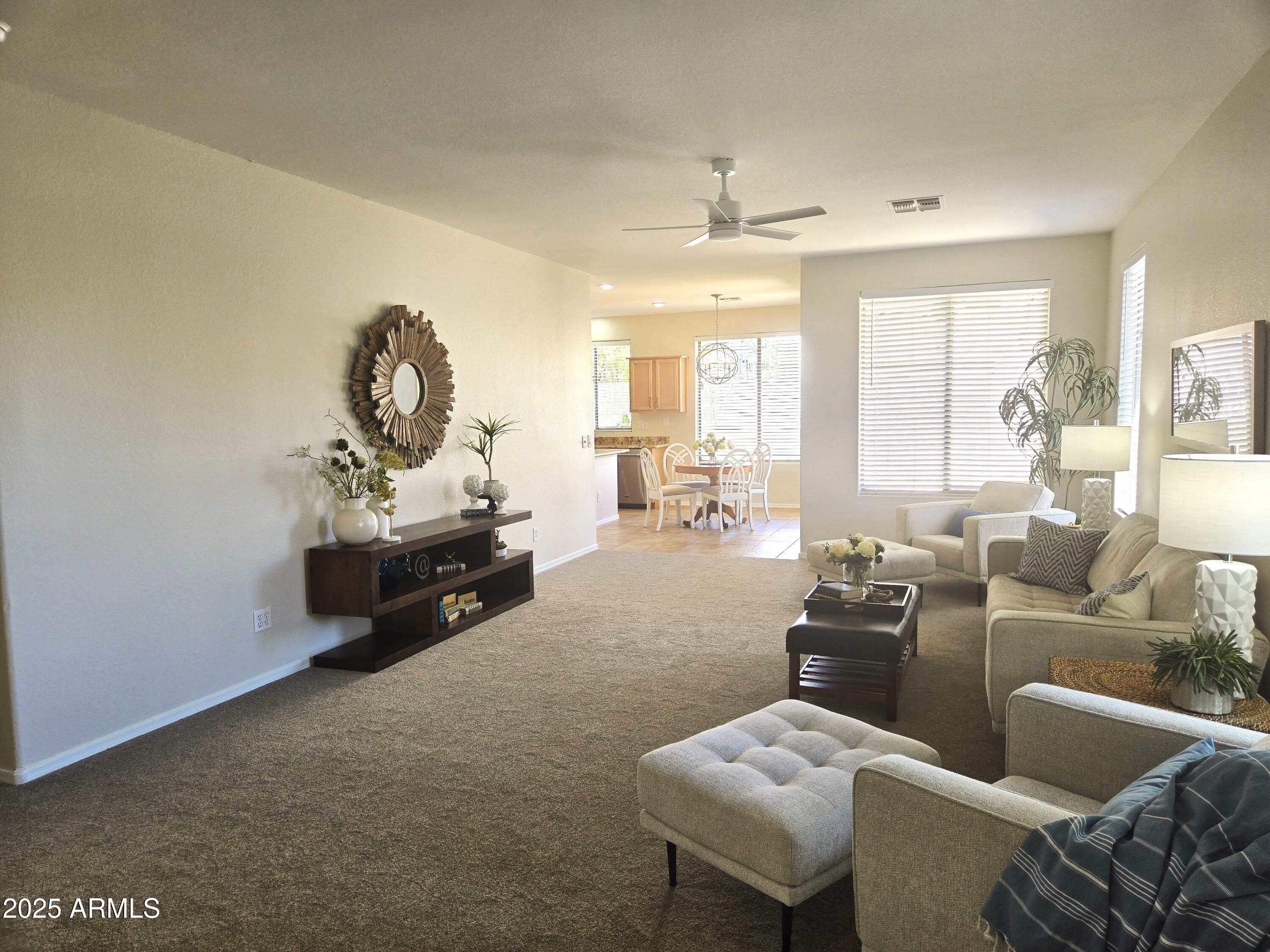 1187 South Hazel Street Gilbert, AZ 85296 - Photo 3 of 50 a living room with furniture and a chandelier