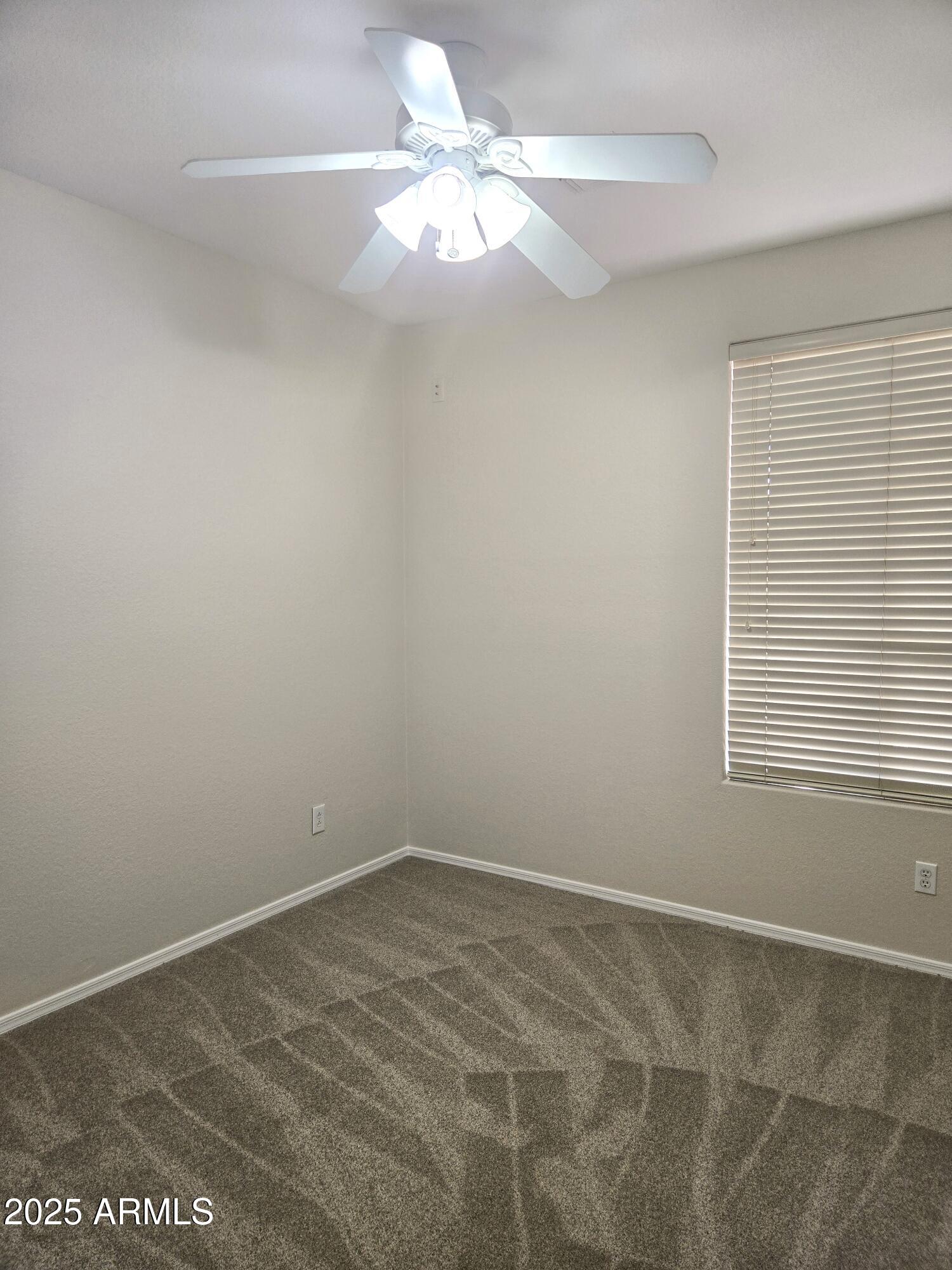 1187 South Hazel Street Gilbert, AZ 85296 - Photo 31 of 50 an empty room with a window and a fan