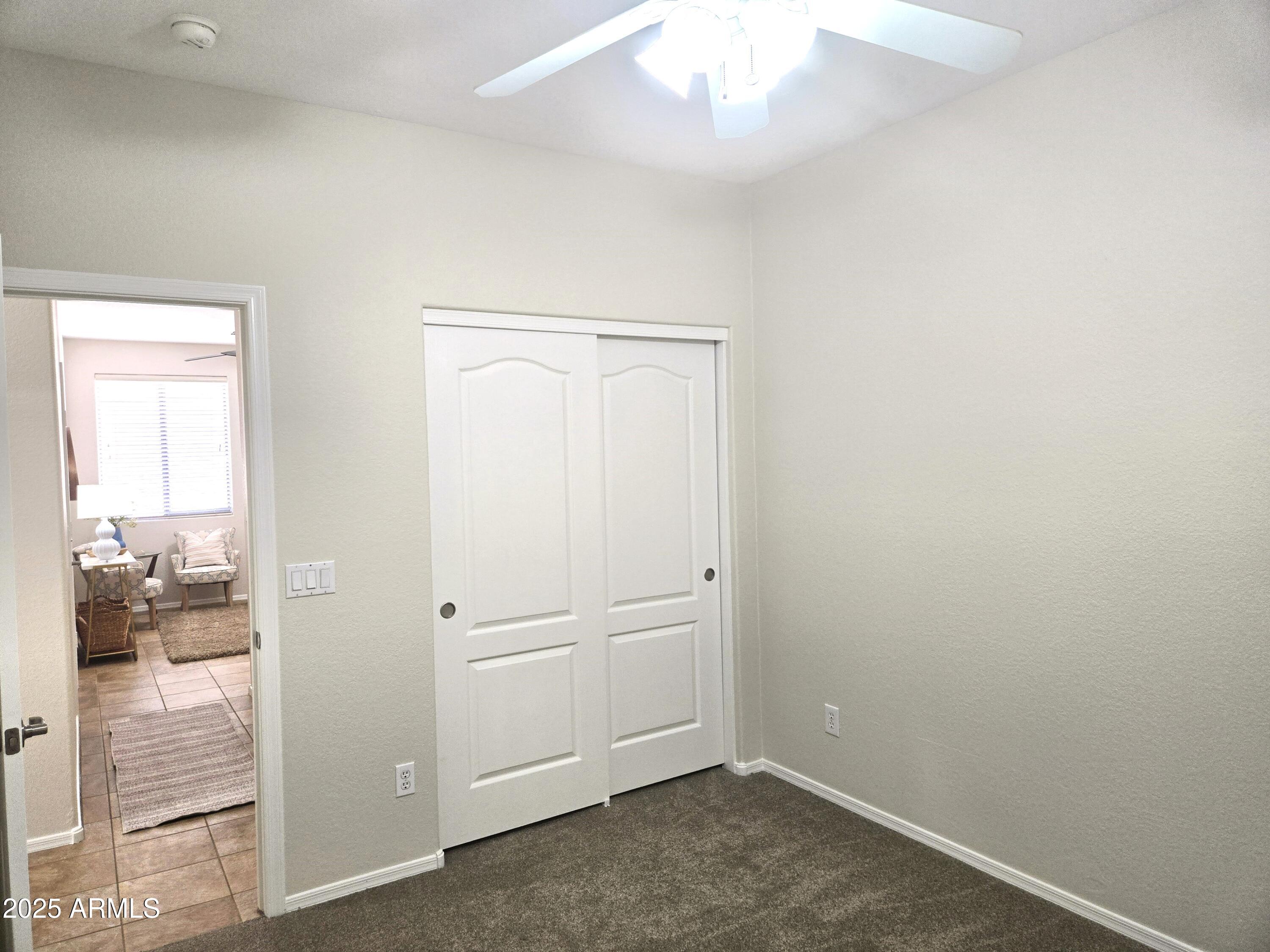 1187 South Hazel Street Gilbert, AZ 85296 - Photo 37 of 50 an empty room with wooden floor and windows