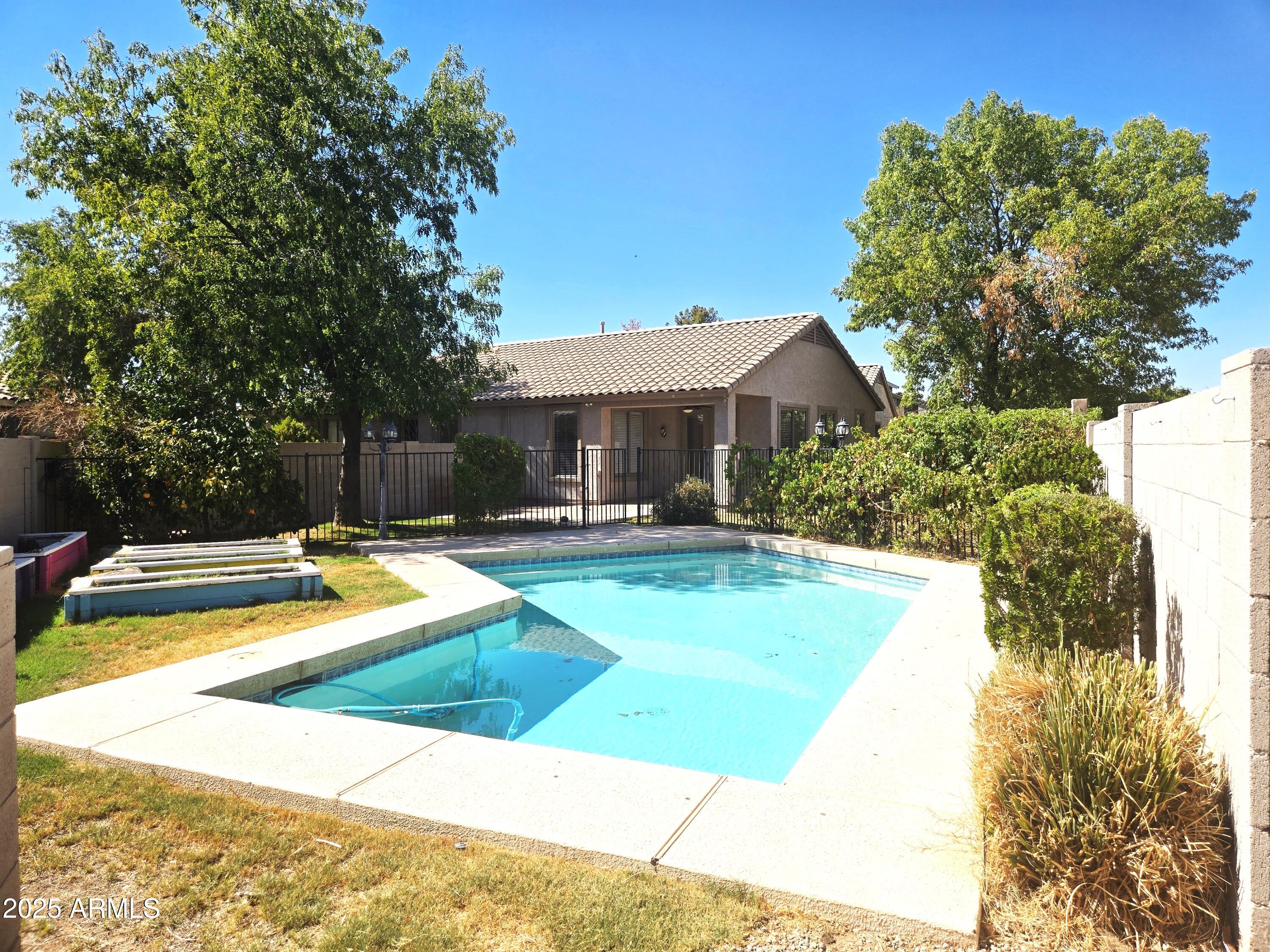 1187 South Hazel Street Gilbert, AZ 85296 - Photo 5 of 50 a view of a house with swimming pool and sitting area