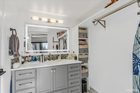 a bathroom with a double vanity sink and a mirror