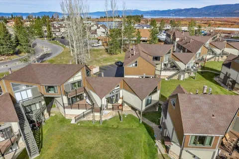 an aerial view of a house with a swimming pool yard and outdoor seating