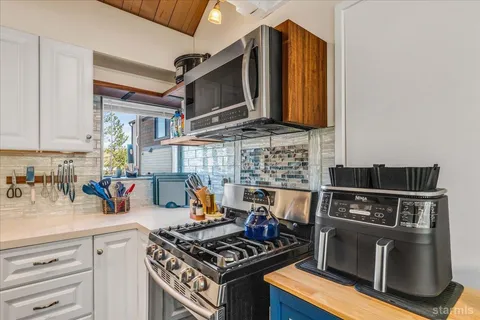 a kitchen with a stove and a microwave