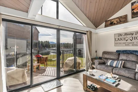 a living room with furniture and a floor to ceiling window