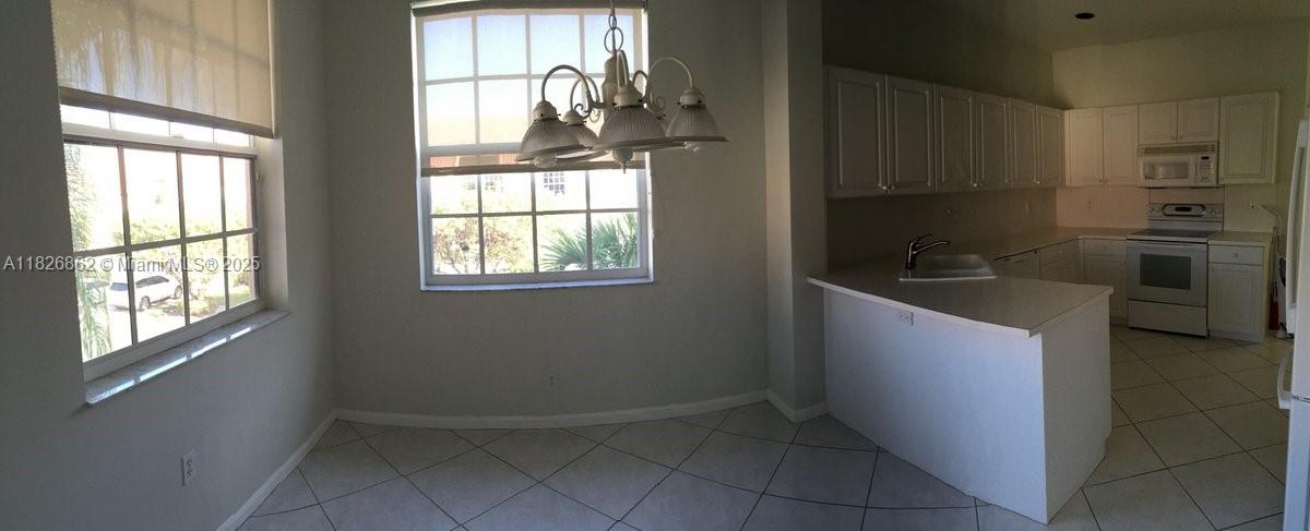 Boca del Mar Boca Raton, FL 33433 - Photo 5 of 11 a kitchen with granite countertop a refrigerator and a sink