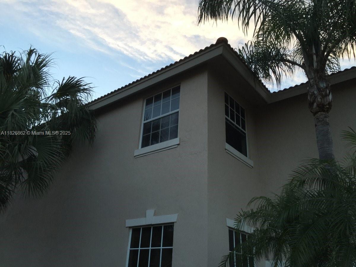 Boca del Mar Boca Raton, FL 33433 - Photo 10 of 11 a black brick house with a small yard next to a road