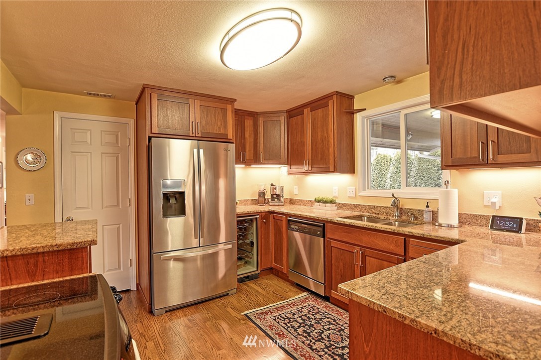 2104 Cedar Road Lake Stevens, WA 98258 - Photo 4 of 19 a kitchen with stainless steel appliances granite countertop a refrigerator sink and cabinets