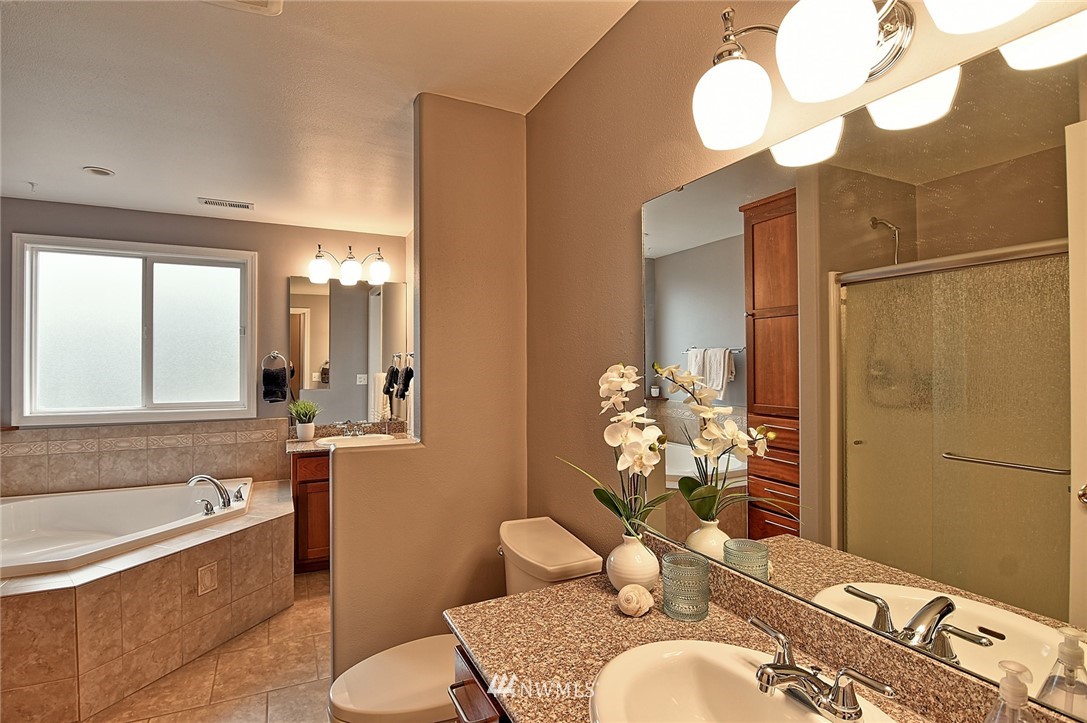 2104 Cedar Road Lake Stevens, WA 98258 - Photo 8 of 19 a bathroom with a granite countertop sink mirror and a bathtub