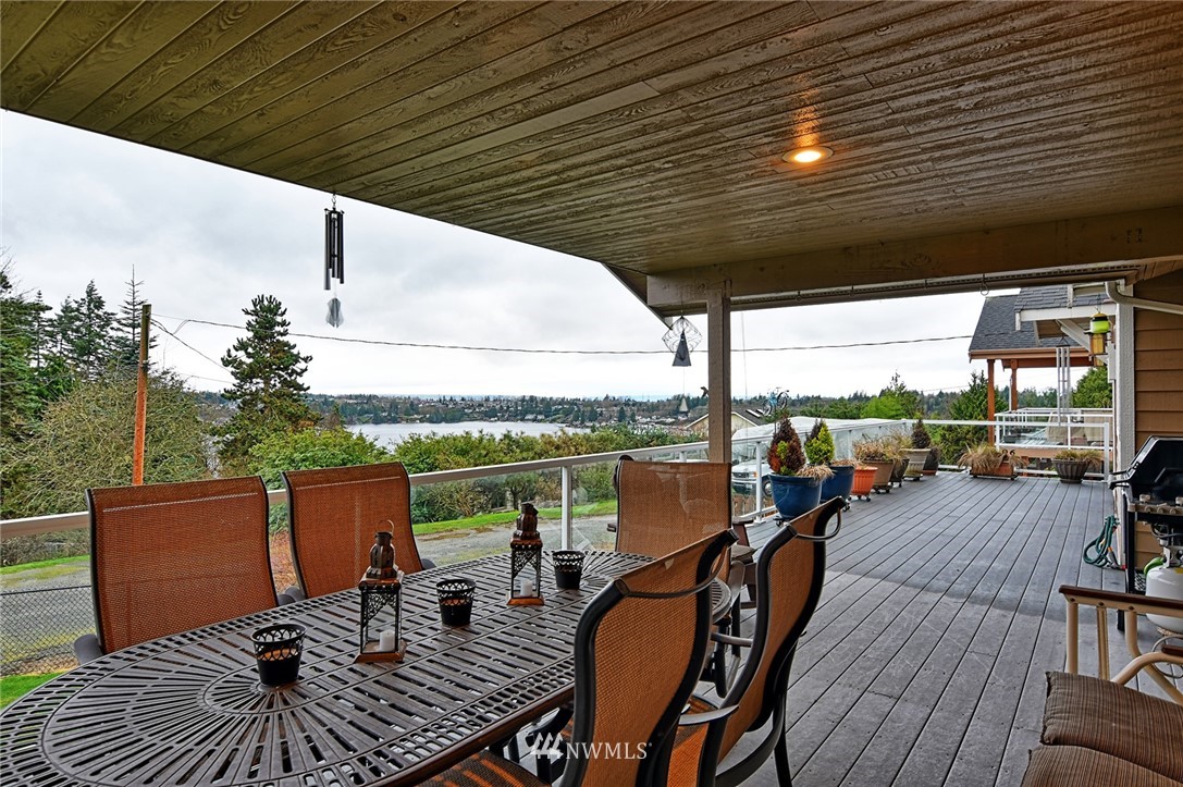 2104 Cedar Road Lake Stevens, WA 98258 - Photo 10 of 19 a view of deck with table and chairs and wooden floor