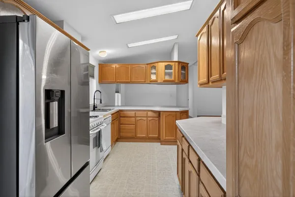 a kitchen with stainless steel appliances granite countertop a refrigerator and a sink