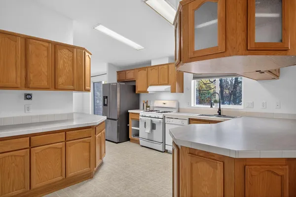 a kitchen with a sink stove and cabinets