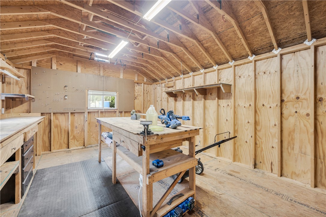 308 Verner Street Walhalla, SC 29691 - Photo 32 of 49 Exposed wood framing and integrated workbenches define this functional workshop space.