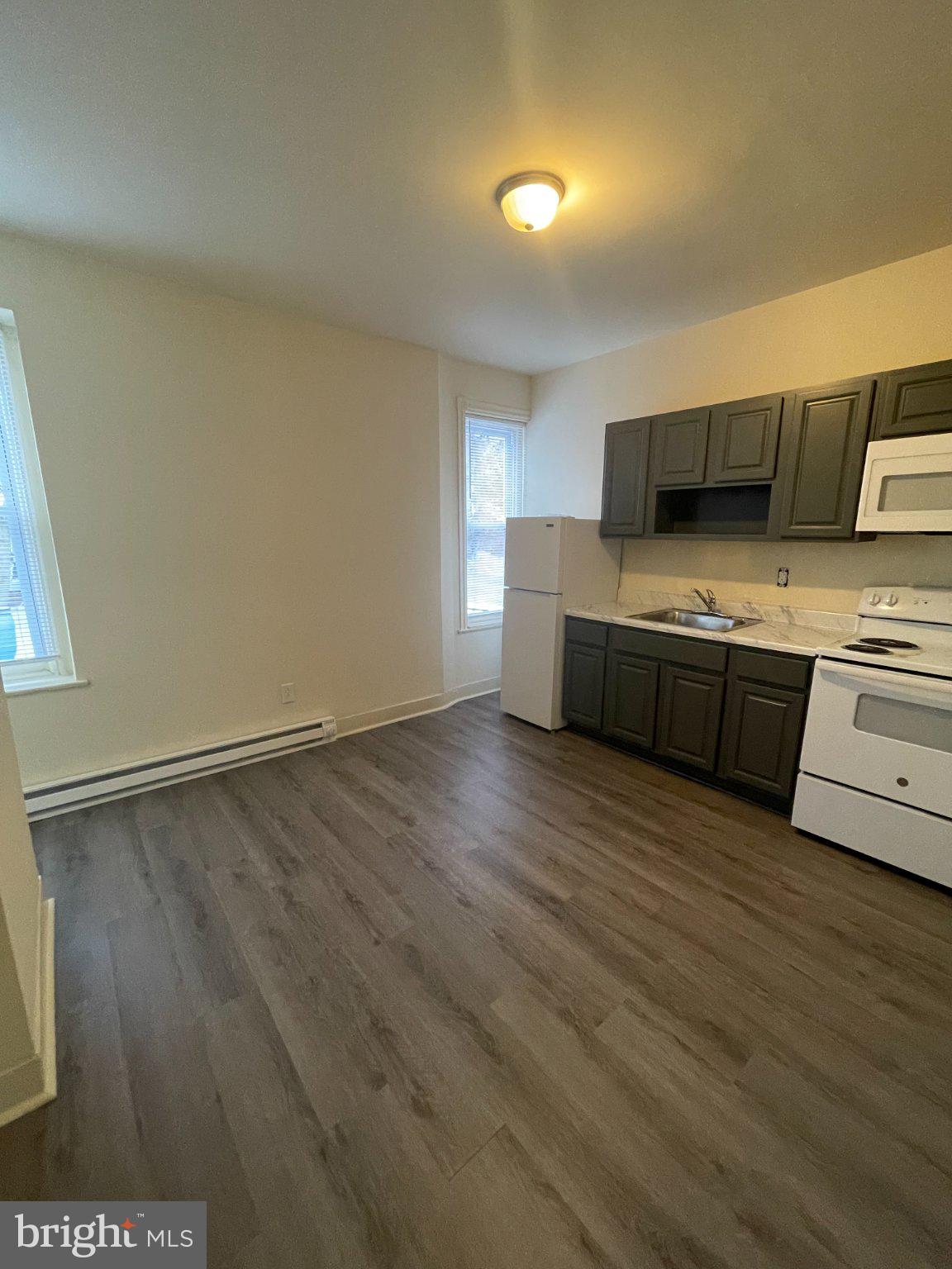 5122 Arch Street Philadelphia, PA 19139 - Photo 12 of 18 a view of kitchen with stainless steel appliances wooden floor and large window