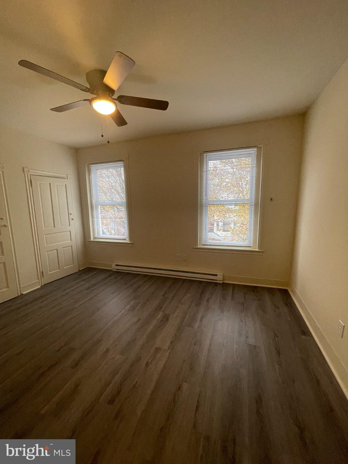 5122 Arch Street Philadelphia, PA 19139 - Photo 14 of 18 an empty room with wooden floor fan and windows