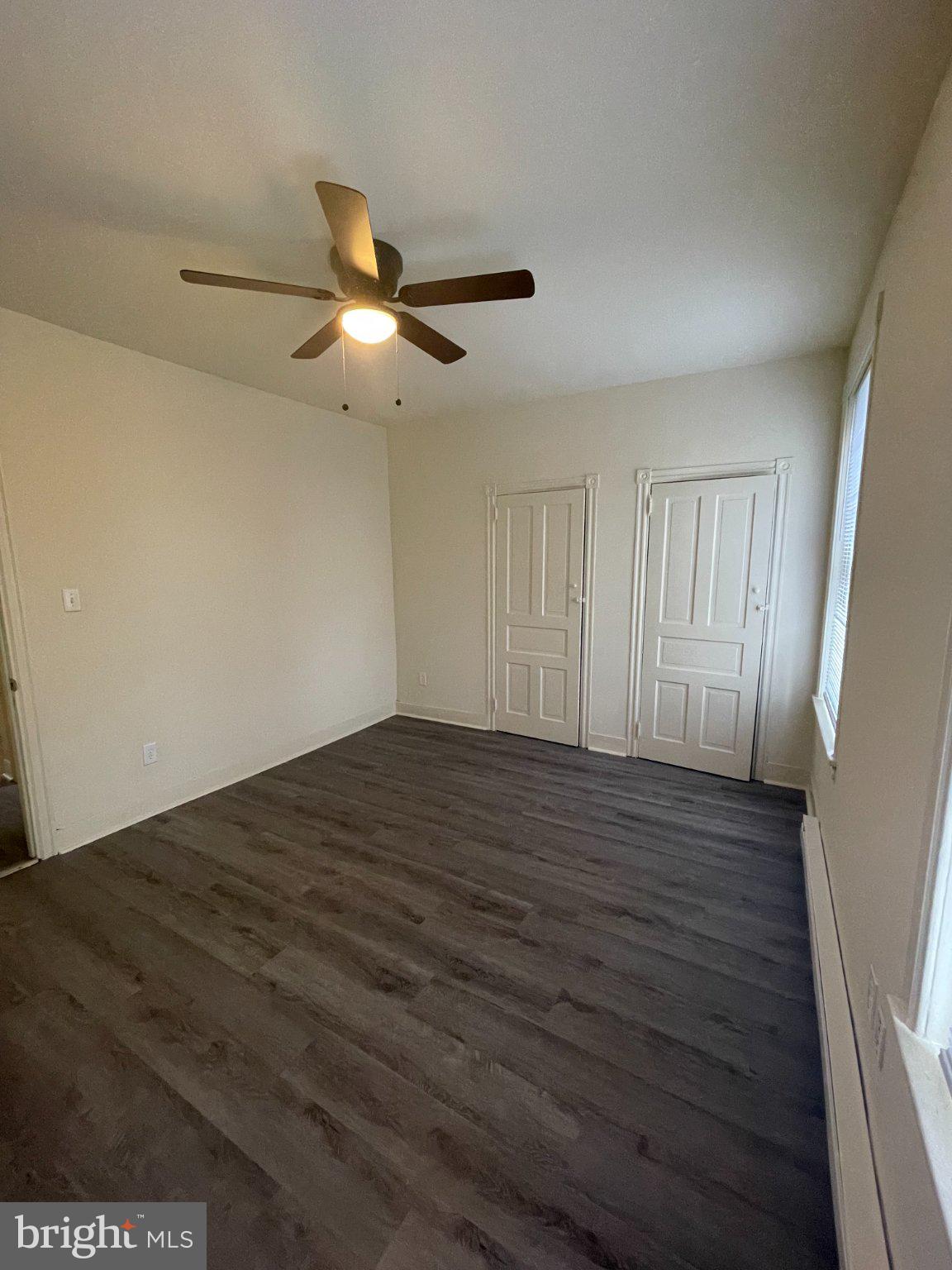 5122 Arch Street Philadelphia, PA 19139 - Photo 15 of 18 a view of empty room with wooden floor and fan