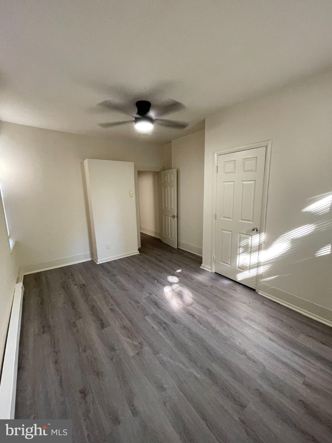 5122 Arch Street Philadelphia, PA 19139 - Photo 4 of 18 an empty room with wooden floor and windows