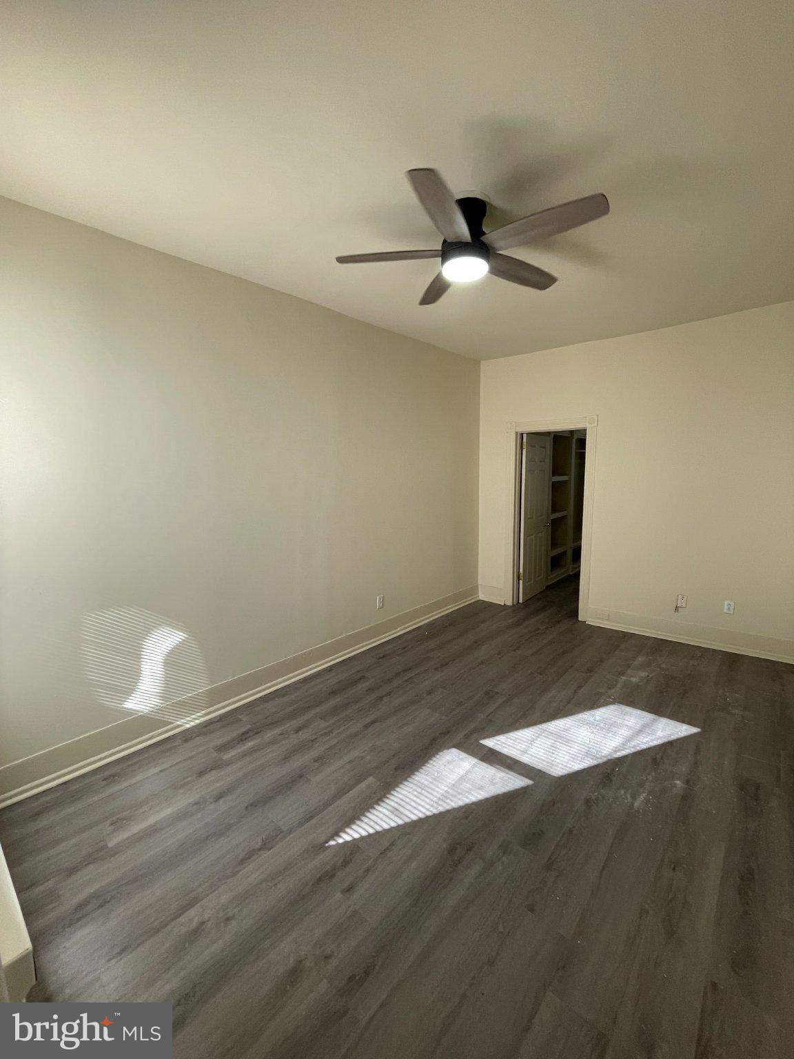 5122 Arch Street Philadelphia, PA 19139 - Photo 6 of 18 an empty room with wooden floor and windows