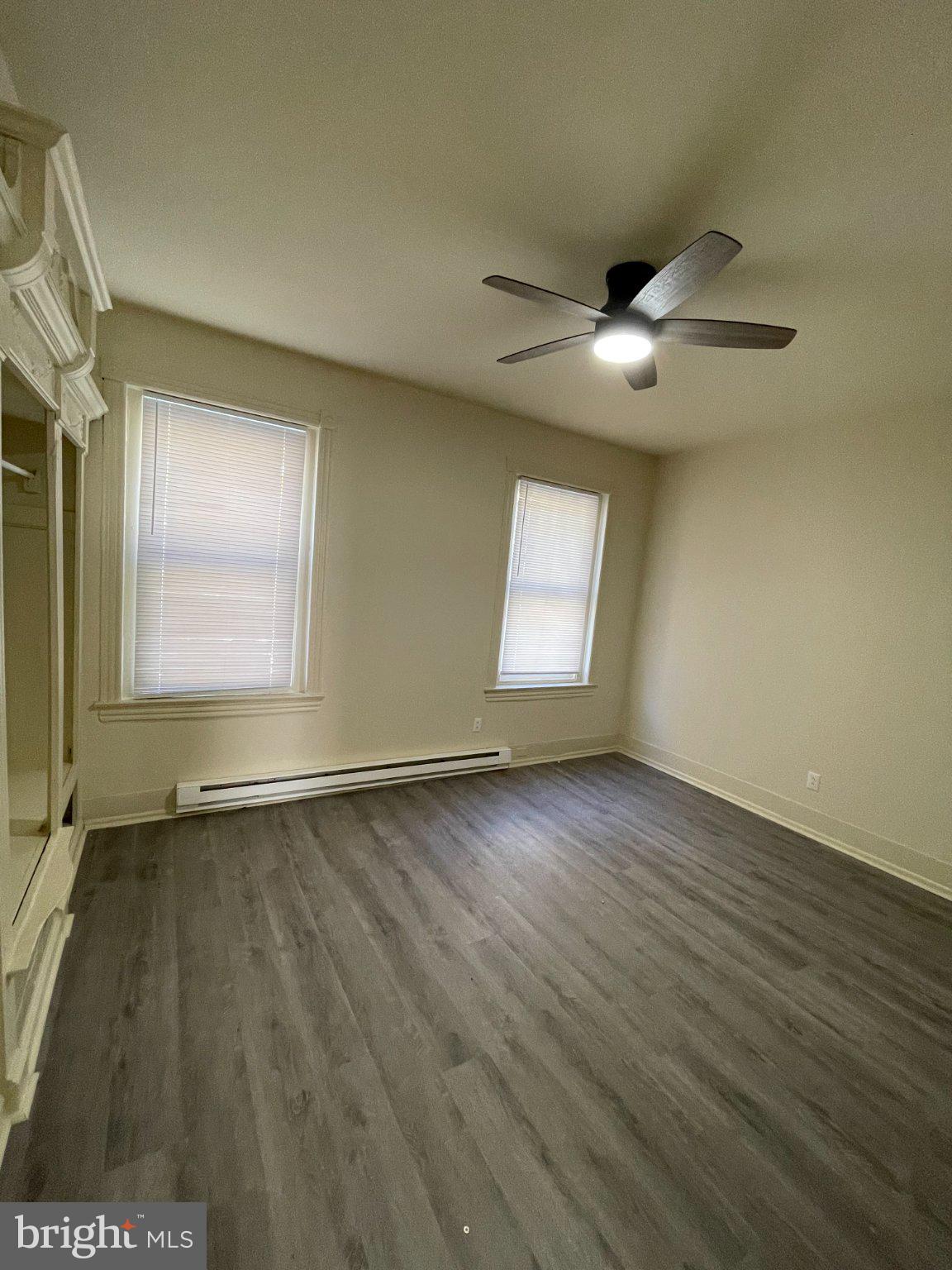5122 Arch Street Philadelphia, PA 19139 - Photo 8 of 18 an empty room with wooden floor chandelier fan and windows