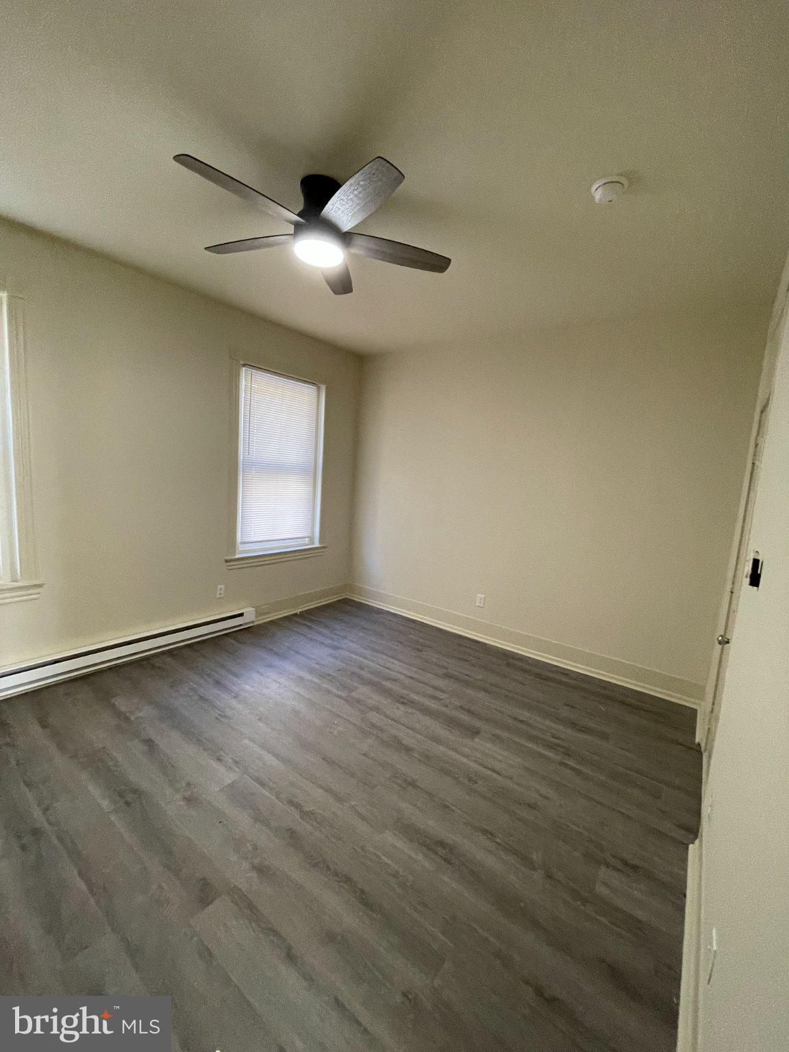 5122 Arch Street Philadelphia, PA 19139 - Photo 9 of 18 an empty room with wooden floor and windows