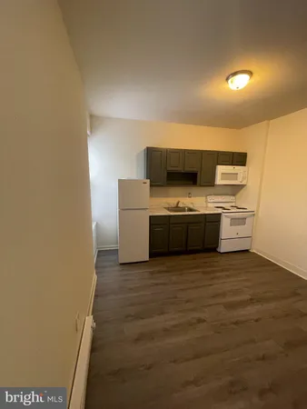 a kitchen with a refrigerator and a stove