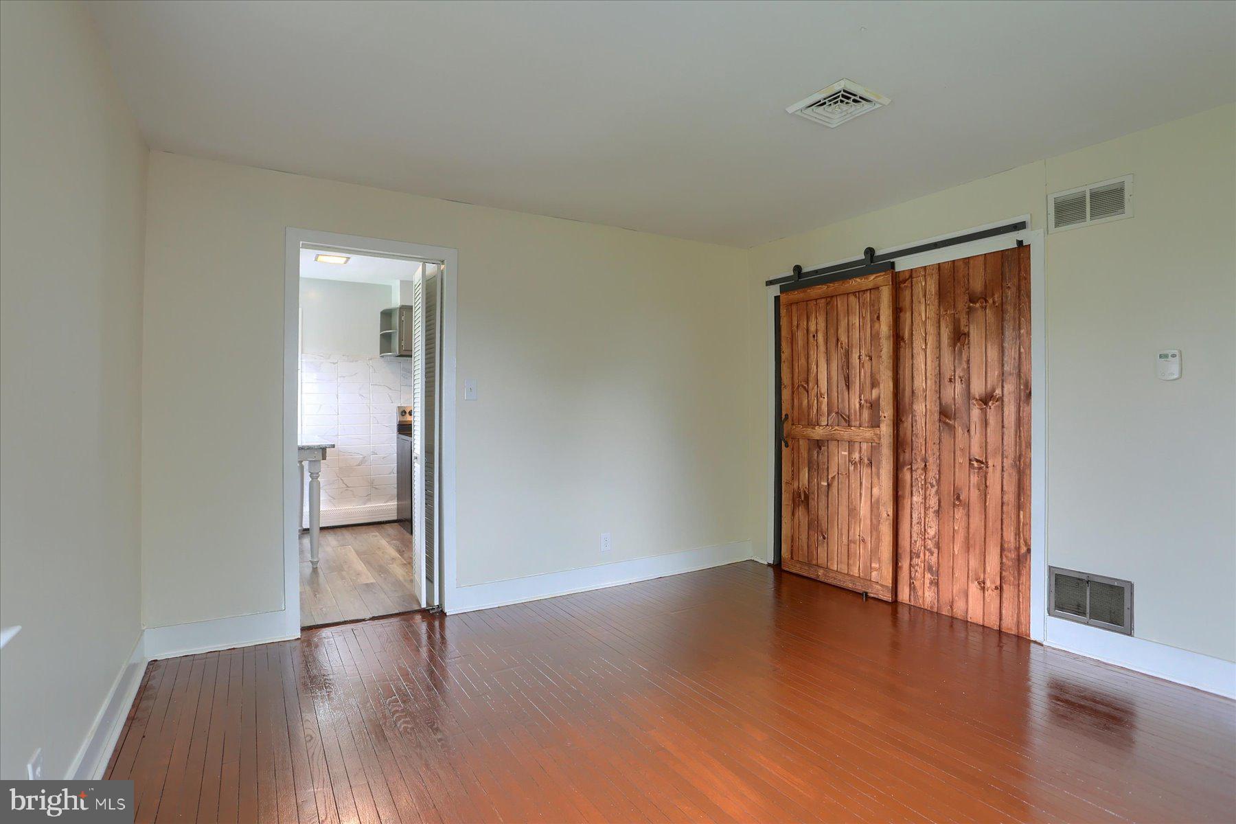2158 Windsor Road Windsor, PA 17366 - Photo 15 of 30 a view of an empty room with wooden floor and a window