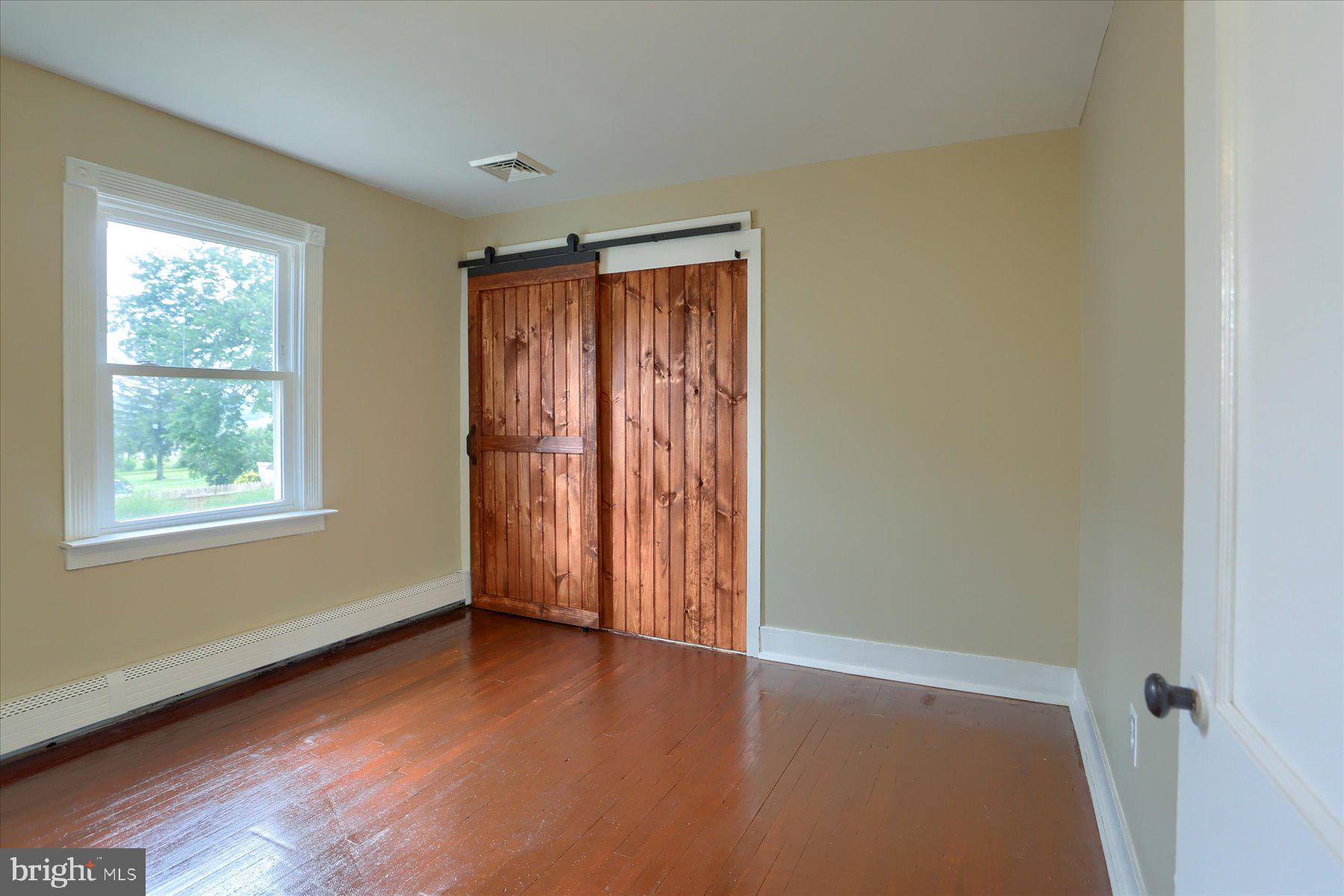2158 Windsor Road Windsor, PA 17366 - Photo 16 of 30 an empty room with wooden floor and windows