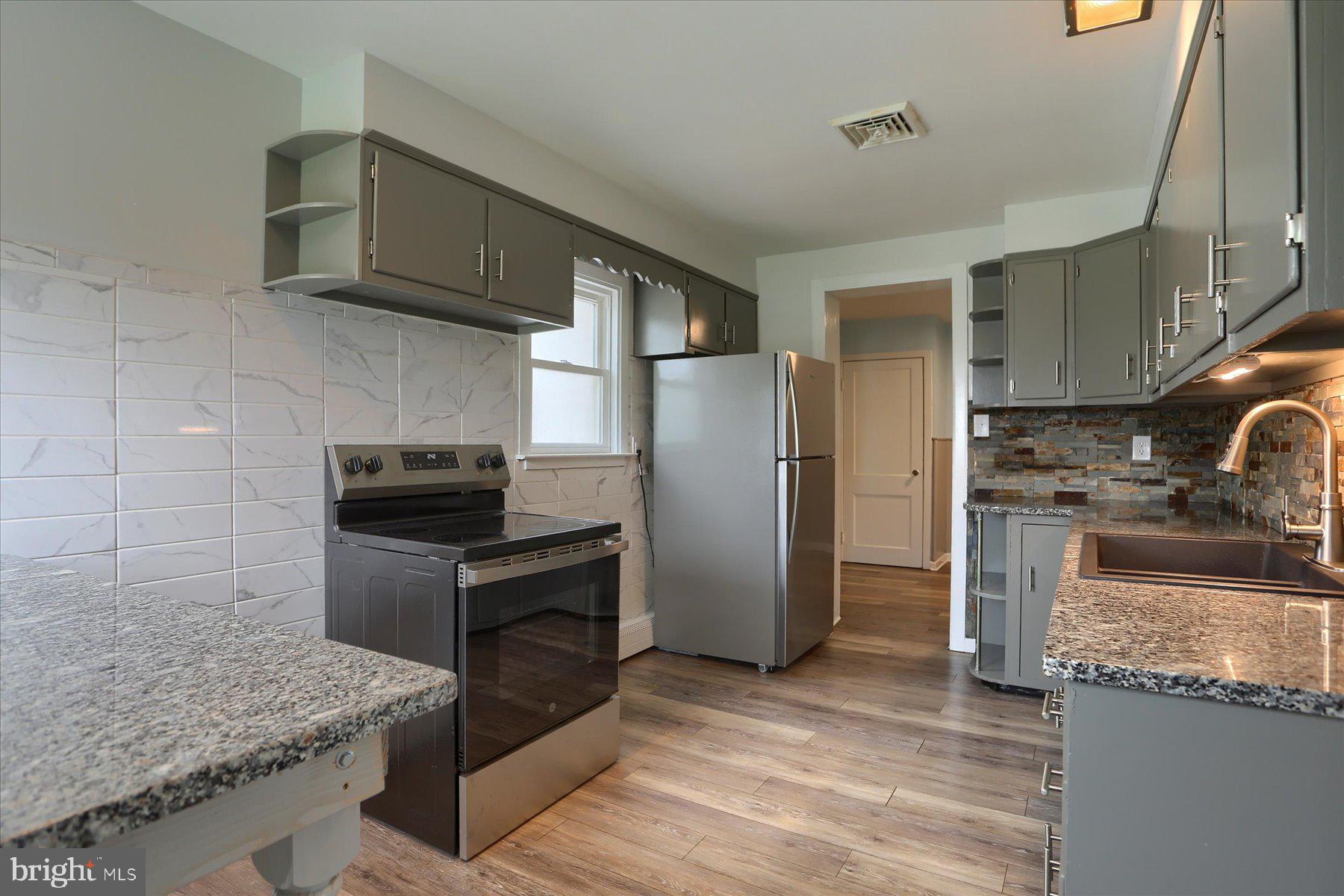 2158 Windsor Road Windsor, PA 17366 - Photo 6 of 30 a kitchen with granite countertop a sink stove and refrigerator