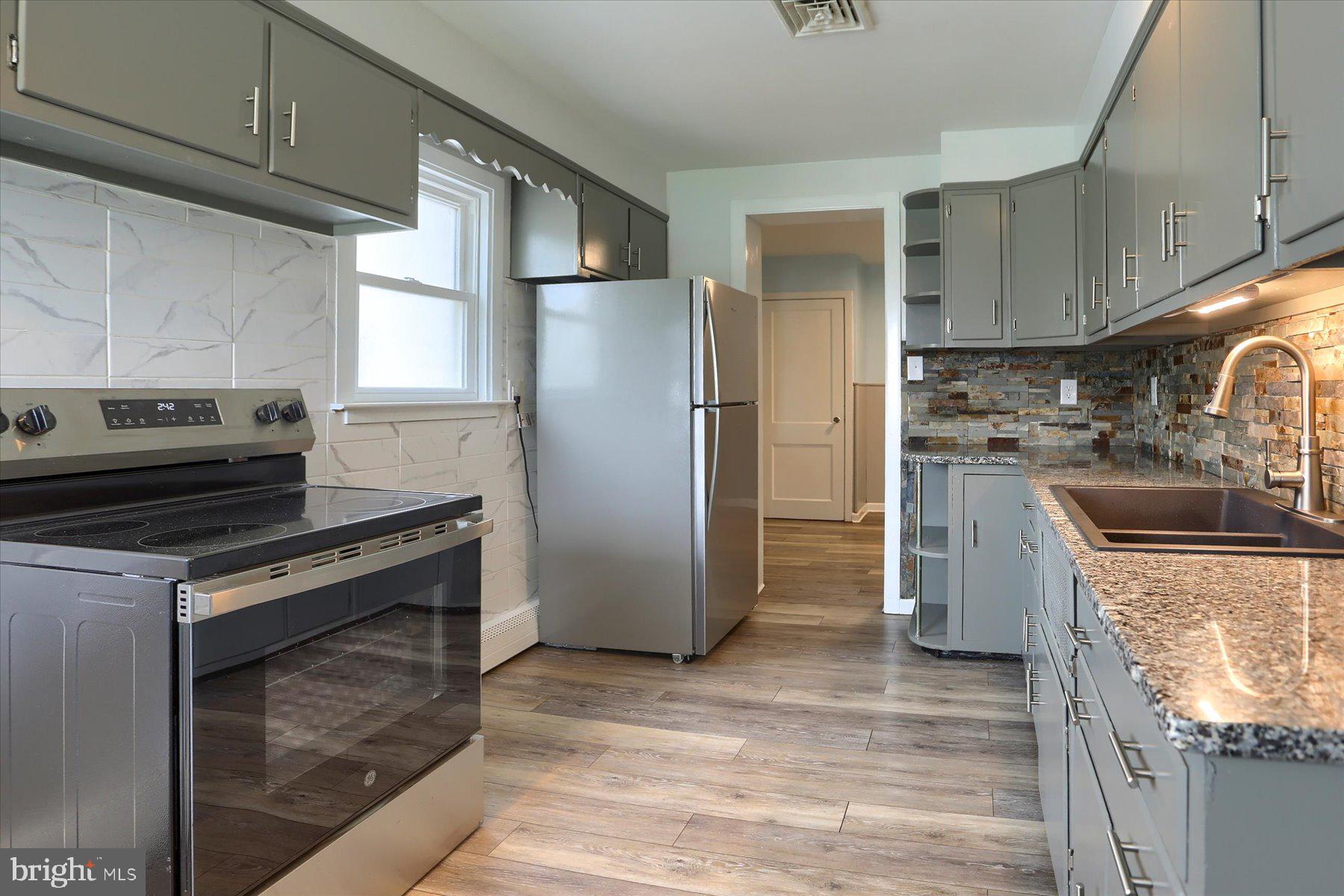 2158 Windsor Road Windsor, PA 17366 - Photo 7 of 30 a kitchen with granite countertop a stove top oven and refrigerator