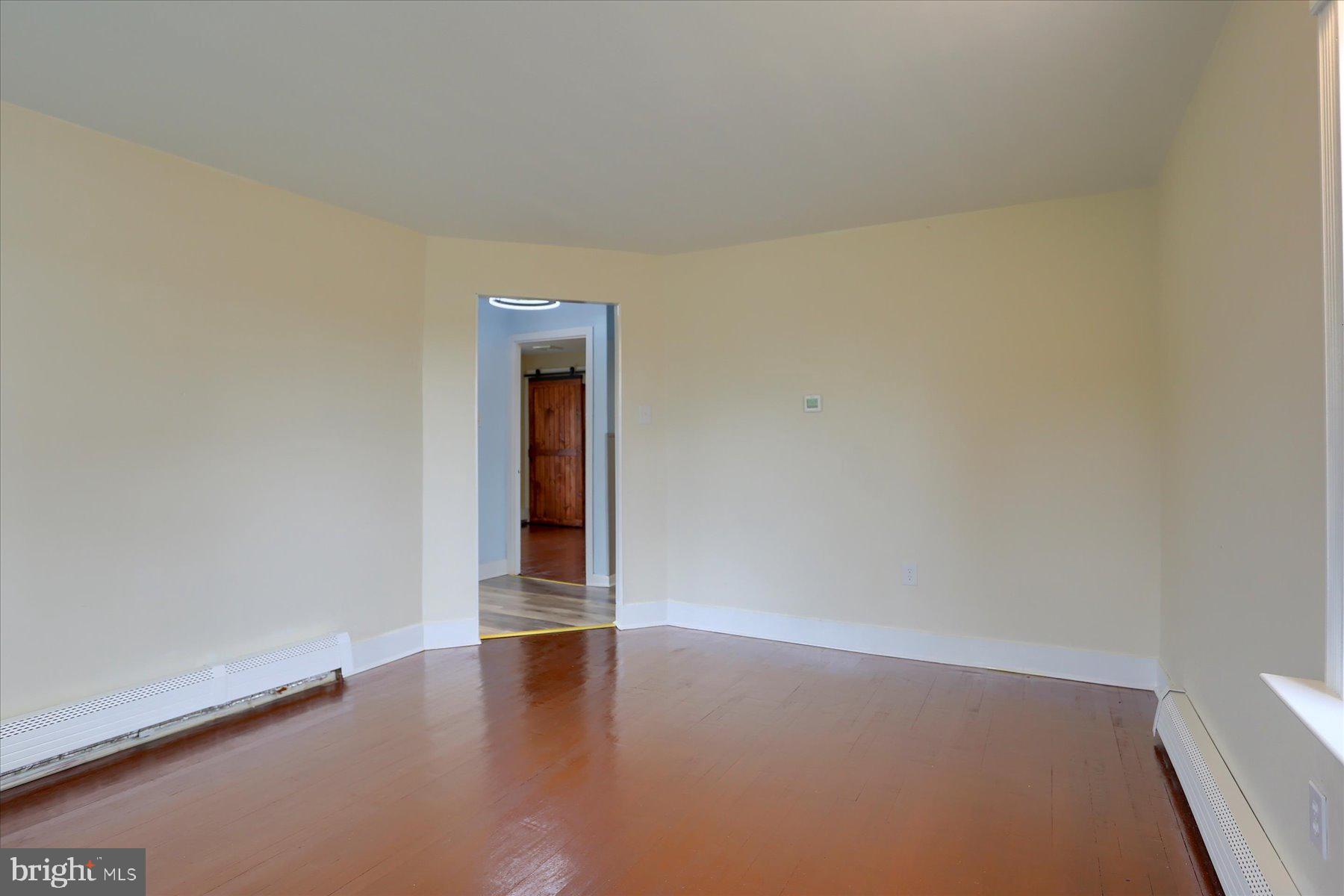 2158 Windsor Road Windsor, PA 17366 - Photo 8 of 30 a view of an empty room with wooden floor and a window