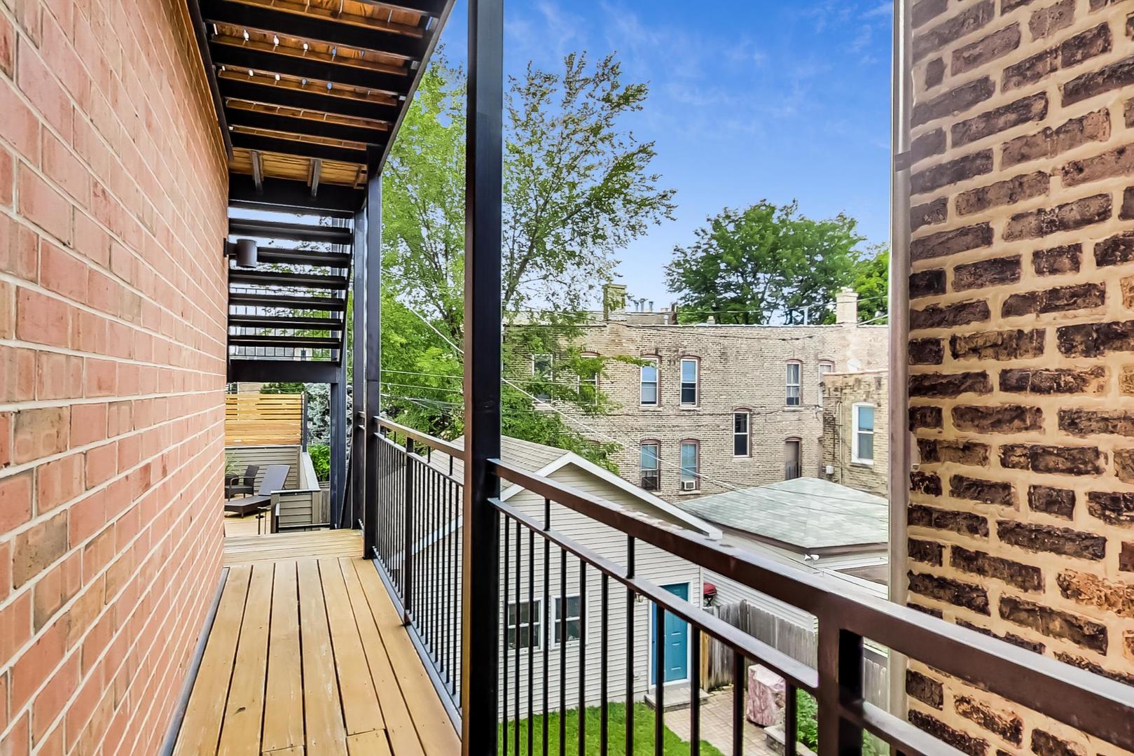 1944 West Thomas Street, Unit 2 Chicago, IL 60622 - Photo 22 of 28 a view of a balcony with a floor to ceiling window with wooden floor