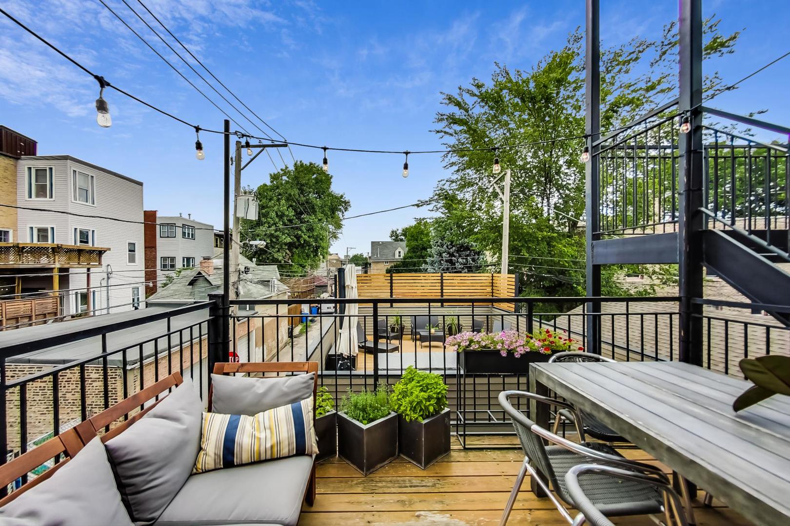 1944 West Thomas Street, Unit 2 Chicago, IL 60622 - Photo 24 of 28 a balcony with wooden floor and outdoor seating