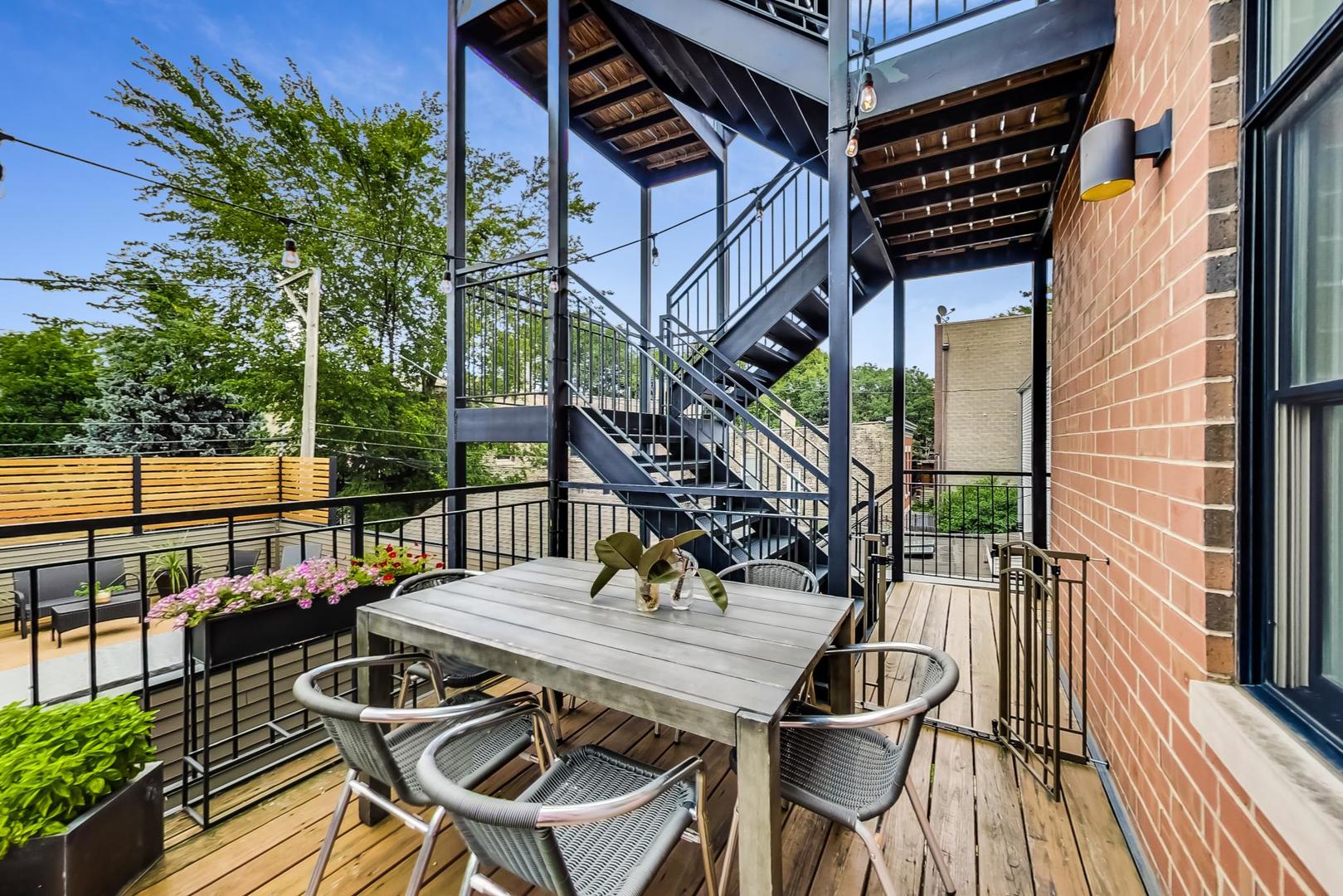 1944 West Thomas Street, Unit 2 Chicago, IL 60622 - Photo 25 of 28 a view of a patio with table and chairs and wooden floor