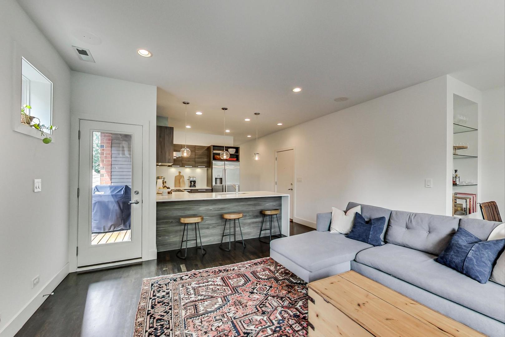 1944 West Thomas Street, Unit 2 Chicago, IL 60622 - Photo 5 of 28 a living room with granite countertop furniture and wooden floor