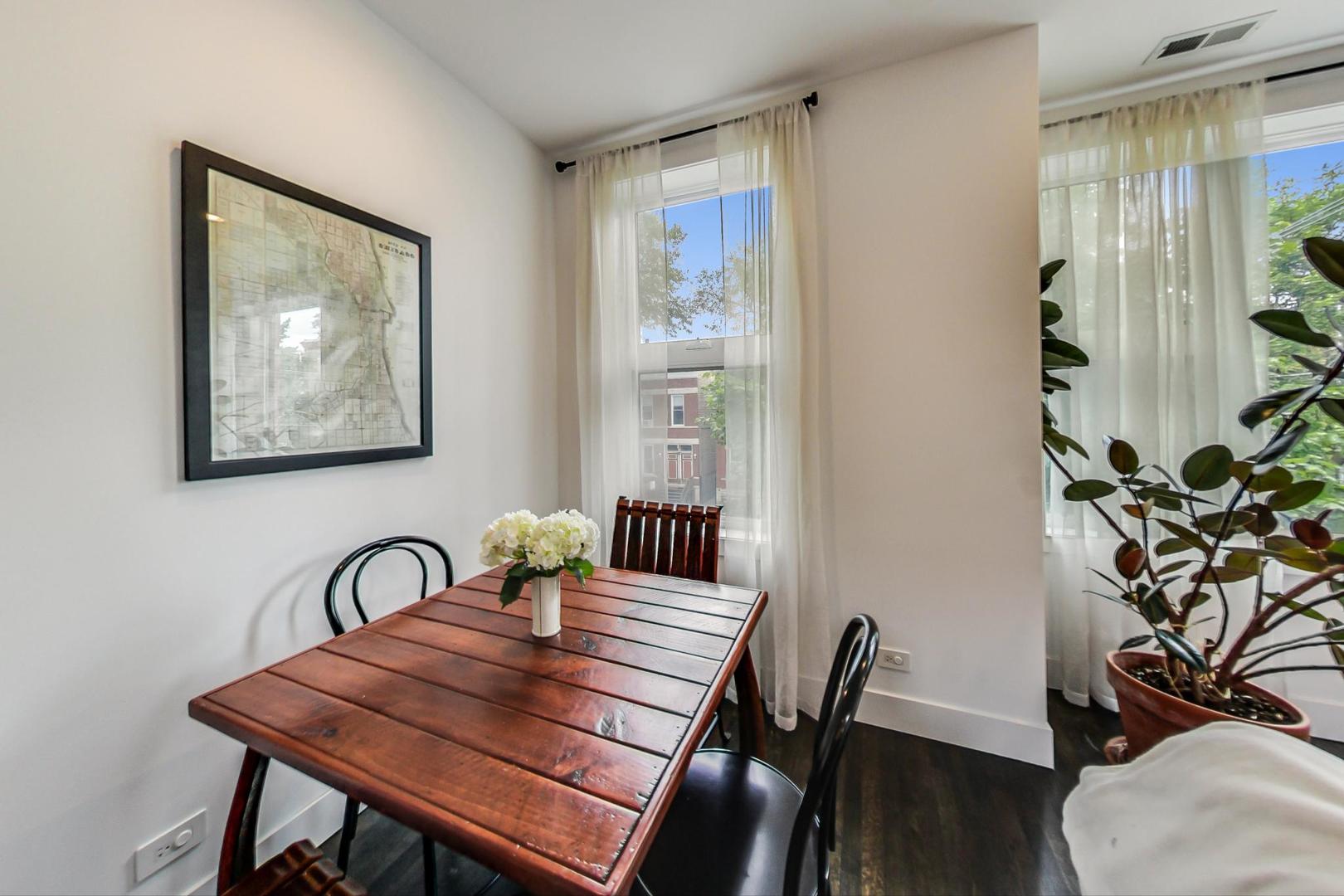 1944 West Thomas Street, Unit 2 Chicago, IL 60622 - Photo 7 of 28 a view of a dining room with furniture window and wooden floor