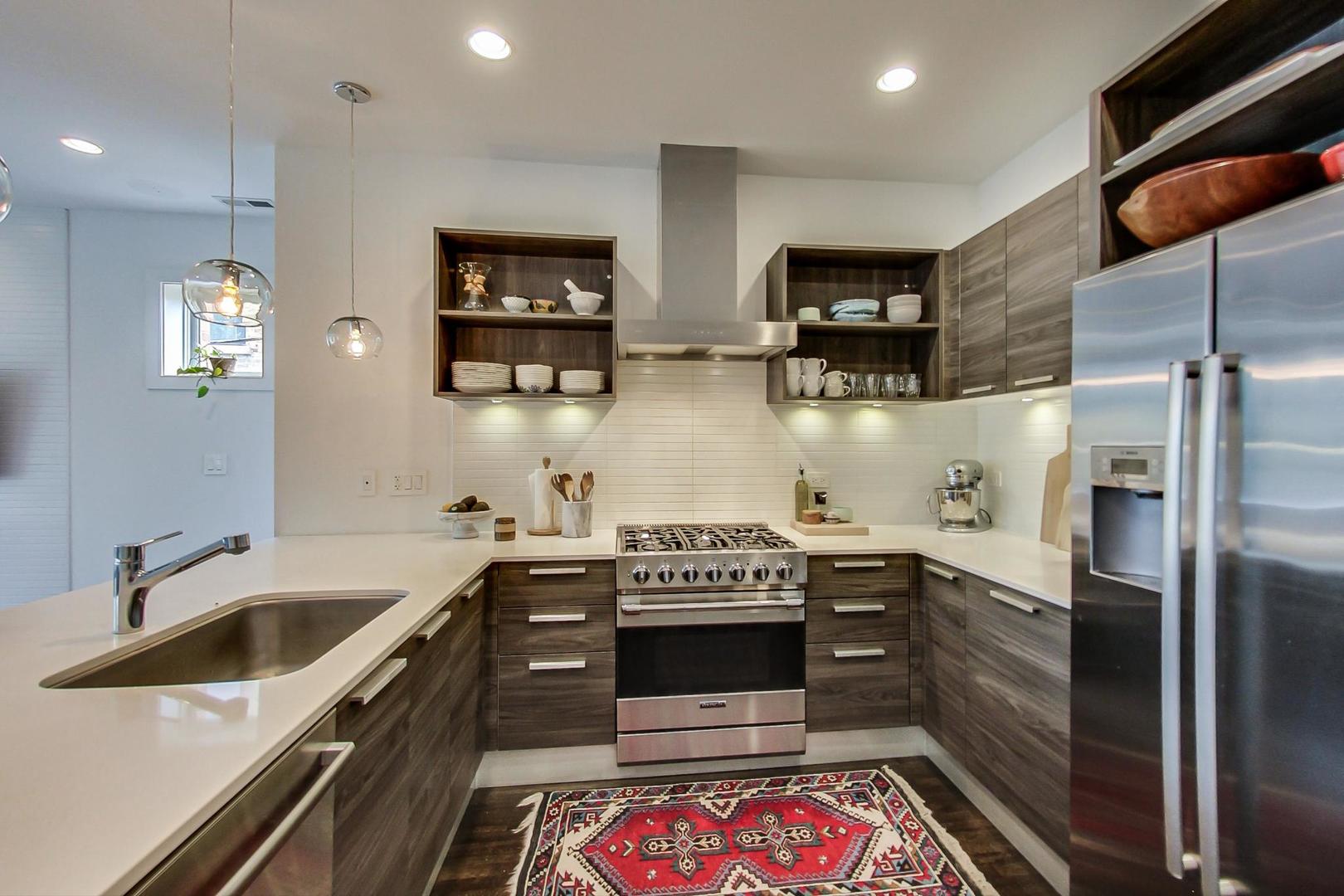 1944 West Thomas Street, Unit 2 Chicago, IL 60622 - Photo 8 of 28 a kitchen with stainless steel appliances a stove a sink and a refrigerator