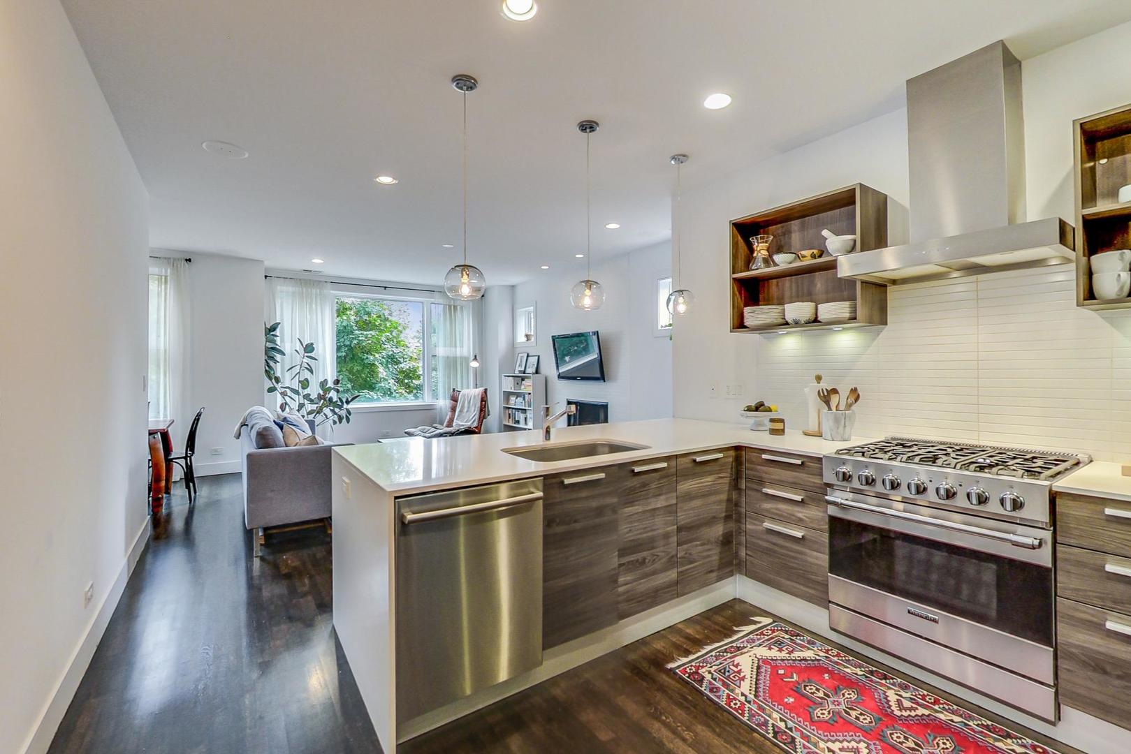 1944 West Thomas Street, Unit 2 Chicago, IL 60622 - Photo 9 of 28 a kitchen with stainless steel appliances granite countertop a stove a sink dishwasher and a refrigerator with wooden floor