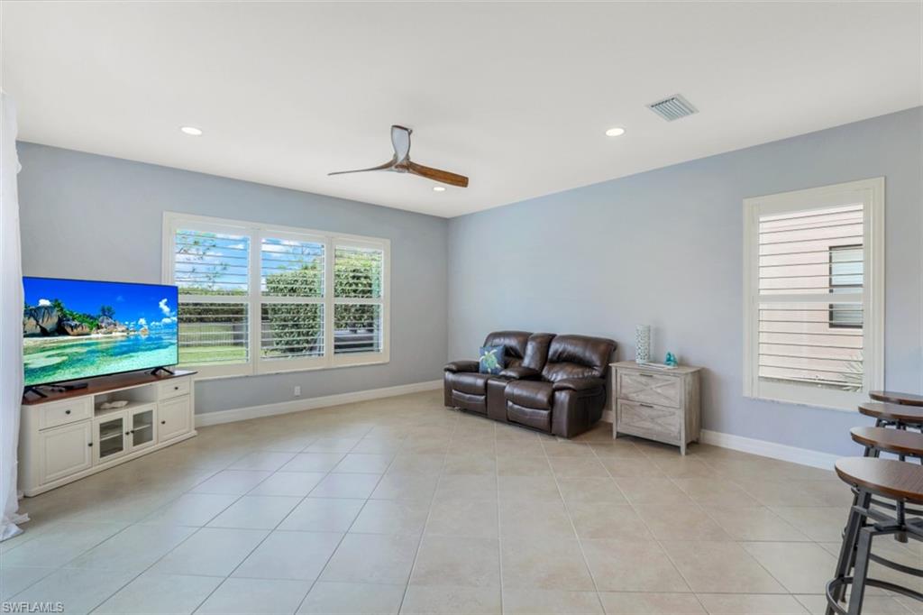 3082 Hudson Terrace Naples, FL 34119 - Photo 12 of 35 a living room with furniture and a flat screen tv