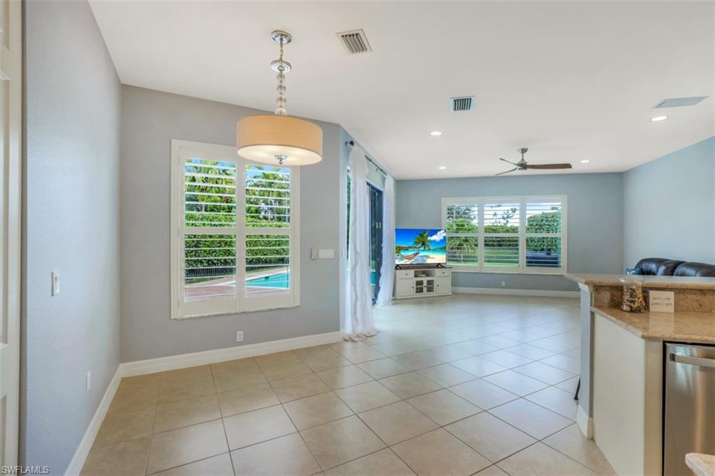 3082 Hudson Terrace Naples, FL 34119 - Photo 13 of 35 a view of a kitchen with furniture and a ceiling fan