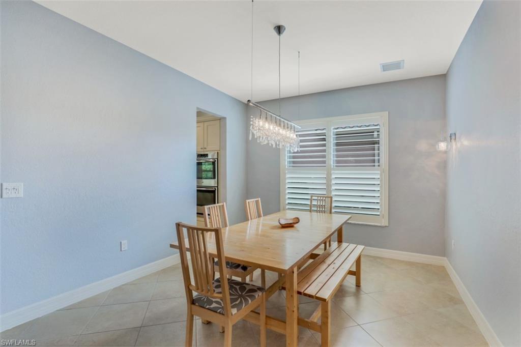 3082 Hudson Terrace Naples, FL 34119 - Photo 14 of 35 a view of a dining room with furniture and window