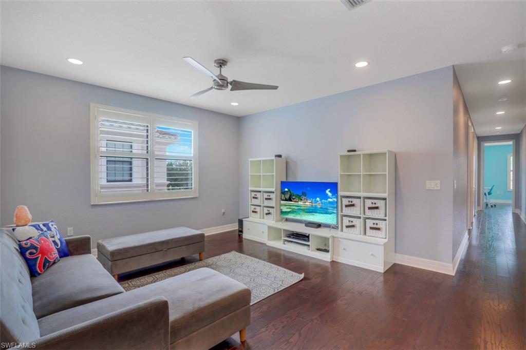 3082 Hudson Terrace Naples, FL 34119 - Photo 19 of 35 a bedroom with furniture and a wooden floor