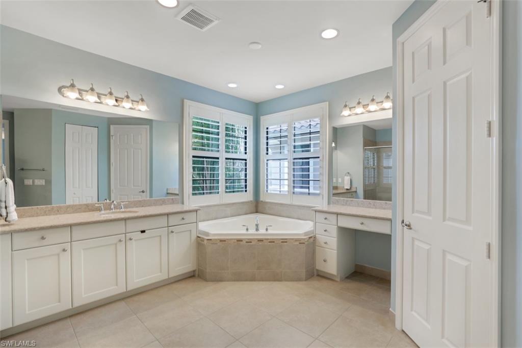 3082 Hudson Terrace Naples, FL 34119 - Photo 24 of 35 a large spacious bathroom with a tub double sink and mirror