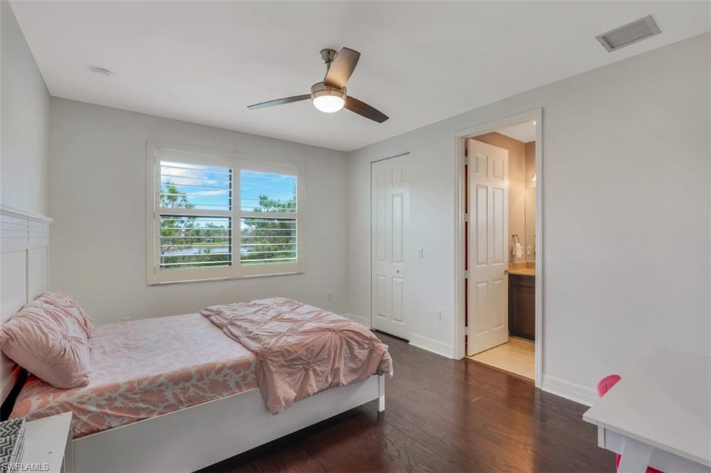 3082 Hudson Terrace Naples, FL 34119 - Photo 27 of 35 a bedroom with a large bed and wooden floor