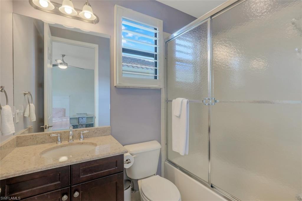 3082 Hudson Terrace Naples, FL 34119 - Photo 28 of 35 a bathroom with a sink toilet vanity and shower