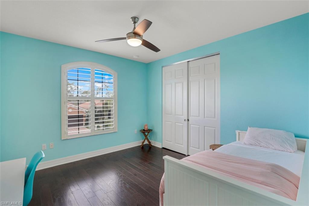 3082 Hudson Terrace Naples, FL 34119 - Photo 32 of 35 a bedroom with a bed and wooden floor