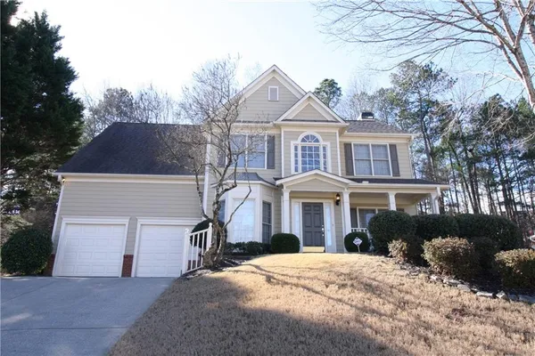 a front view of a house with a yard