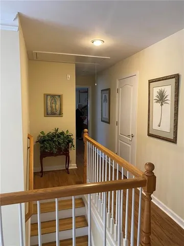 a view of a hallway with a large window and wooden floor