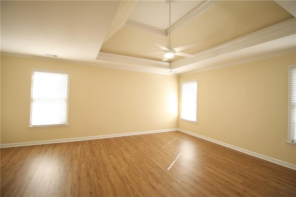 3343 Mill Grove Terrace Dacula, GA 30019 - Photo 14 of 28 an empty room with wooden floor and windows